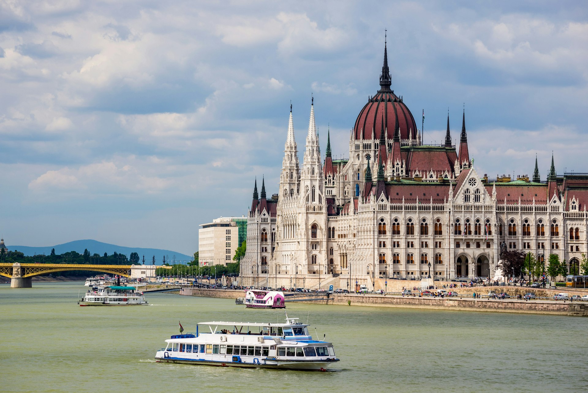Tourist boats pass the Hungarian Parliament in Budapest